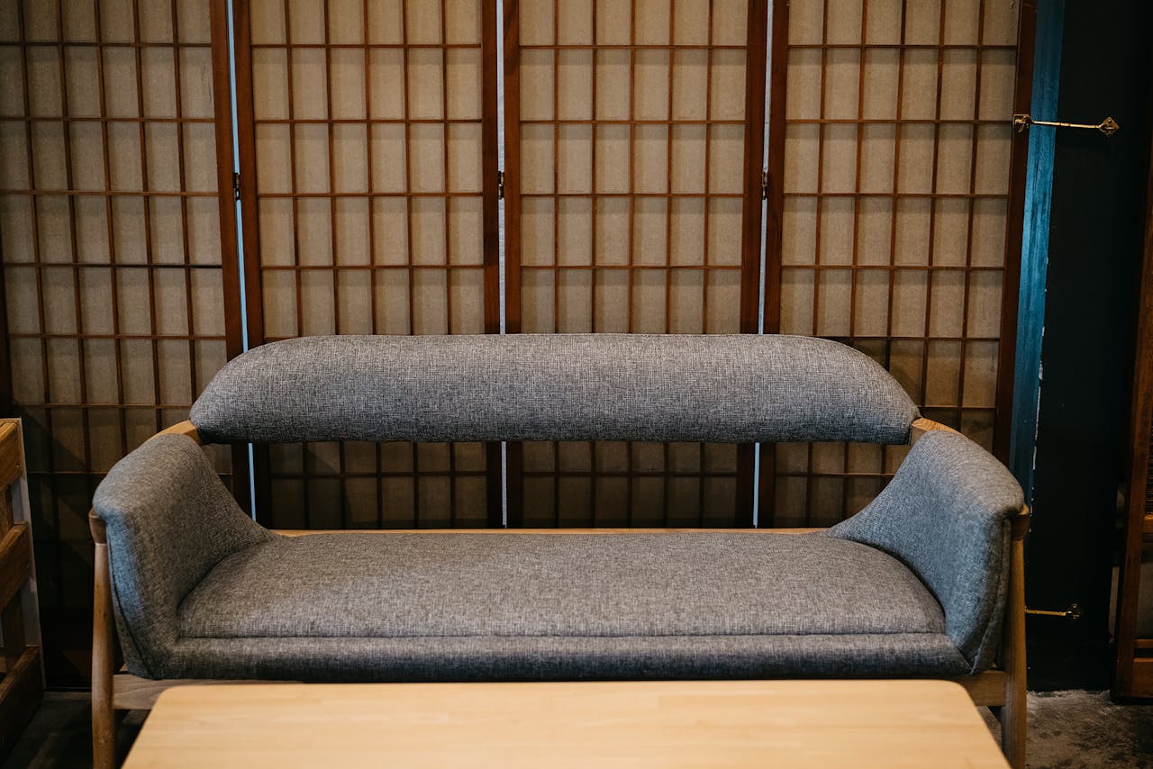 home-hero Elegant minimalist sofa with Japanese shoji screen backdrop creating a tranquil modern interior.